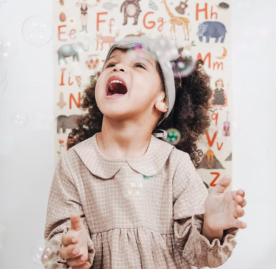 girl catching bubbles