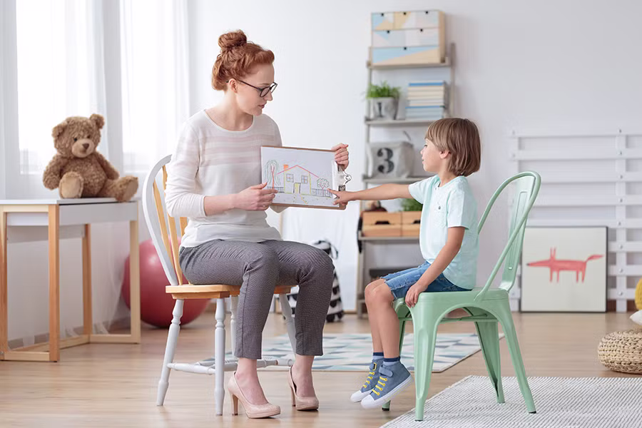 autism therapist working with child